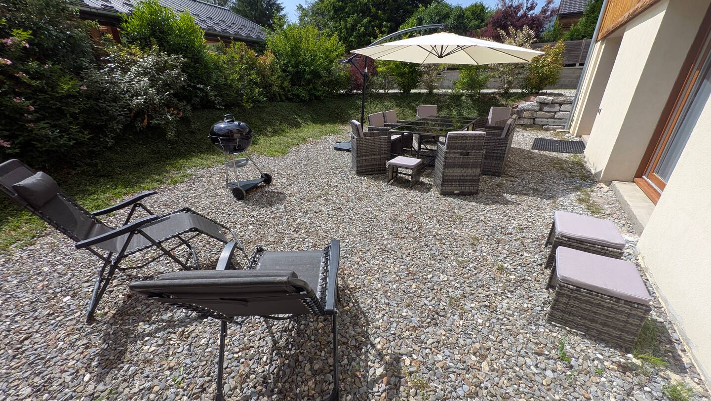 Large south-facing terrace with outdoor seating and garden planting